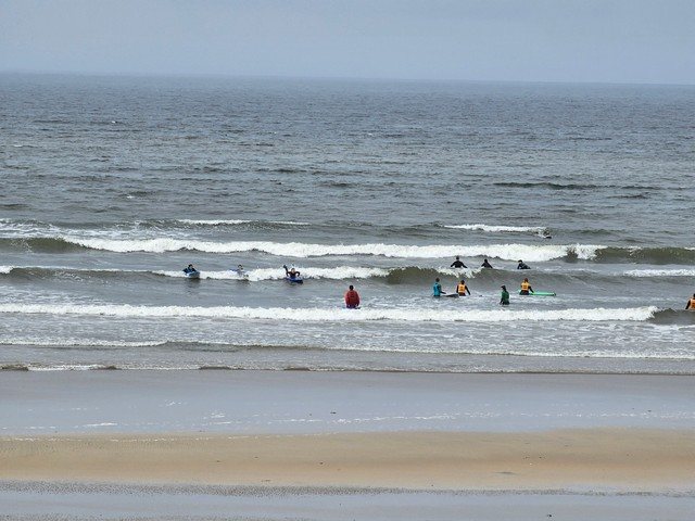 Lots of beginner surfers in the shallows with some lumpy 2 foot waves